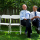 In New Hampshire, Sept. 7, 2012. President Obama sits on a white folding chair next to Vice President Biden joking with the Vice President Joe Biden before a campaign rally in Portsmouth. The two look at each other smiling.